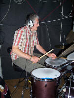 The AJ Jazz Band Jazz quartet drummer wearing headphones.  The band are frequent visitors to wedding