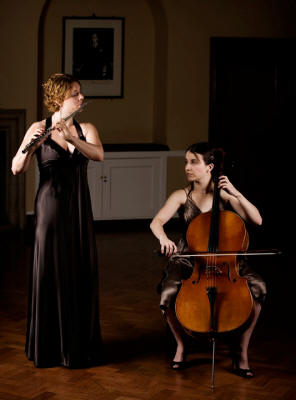 The AC Flute & Cello Duo Duo in long brown dresses. They play in Essex, Surrey and Berkshire
