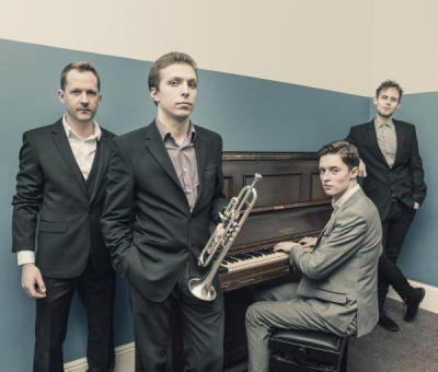 The TC Jazz Quartet Band in lounge suits looking serious. They play in Surrey and London