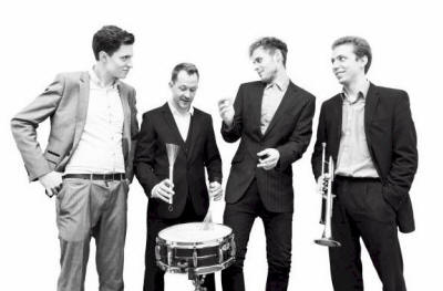 The TC Jazz Quartet Band joking standing around the drummer.  They play in Berkshire and Oxfordshire