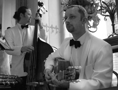 The HC Jazz Quintet Jazz bass & guitar players in white. The band play in Warwickshire